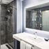 AC Hotels by Marriott San Diego Downtown Gaslamp Quarter bathroom with glass shower and vanity mirror