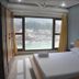 Ganga Beach Resort in Rishikesh room with bed and large window overlooking the river