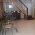 Hotel Trishul Haridwar dining area with tables, chairs, staircase and tiled floor