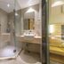 City Comfort Inn Foshan Zumiao Zhangcha bathroom with glass shower, toilet, sink and mirror in Foshan