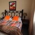 Oak Rest Guesthouse Kimberley guest room with double bed, bedside lamps and floral wall art