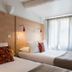 Hôtel Edmond Rostand Marseille twin guest room with two single beds and sheer curtain window