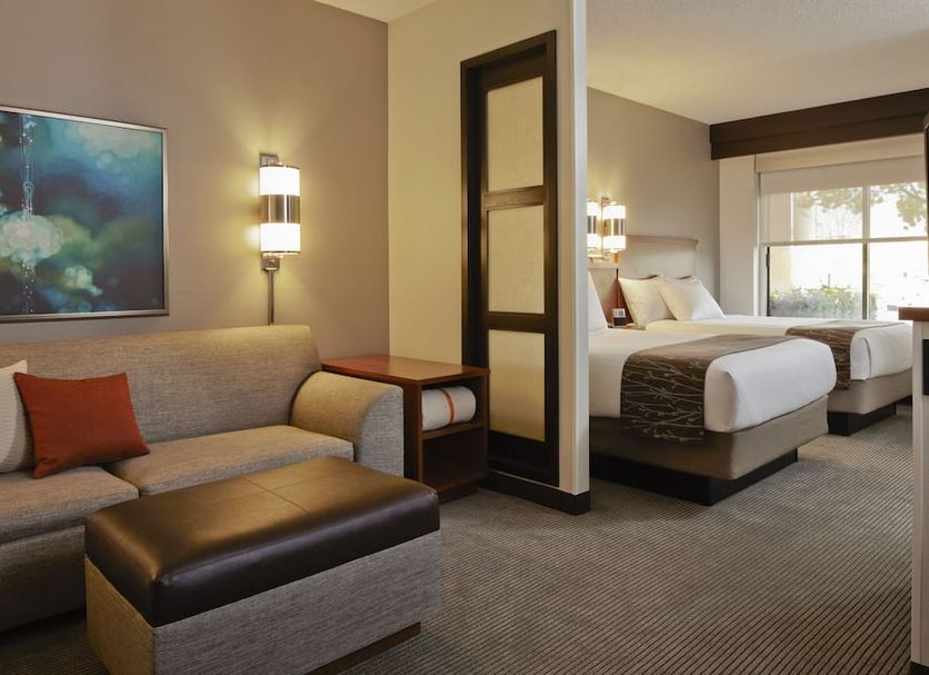 Hyatt Place Fort Worth Cityview guest room with sofa, bed, and city view window