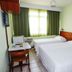 Rede Andrade Atlântico in Piçarras: simple twin room with two beds, desk, and window with curtains