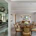 The Ritz-Carlton New York Central Park dining room with oval table, upholstered chairs and mirrored wall accents