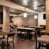 Hilton Garden Inn Jacksonville Ponte Vedra Sawgrass dining area with tables, chairs and brick accents in Ponte Vedra Beach