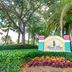 Mizner Place at Weston Town Center sign amid palm trees and landscaping in Weston