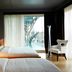 Amadi Park Hotel Amsterdam guest room with twin beds, balcony doors, and city view