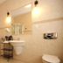 La Petite Apartments & Rooms in Gdansk bathroom with shower, sink, mirror and tiled walls