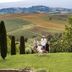Fonteverde Lifestyle & Thermal Retreat in San Casciano Dei Bagni with Tuscan hillside views and guests on the lawn