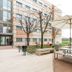 Outdoor terrace at Residencia Universitaria Resa Los Abedules in Pamplona with tables, umbrellas and benches