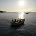 Grand Hôtel De Cala Rossa in Porto-Vecchio with a boat on calm sea at sunset