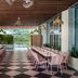 the goodtime hotel, Miami Beach: open-air dining patio with long set tables and checkered floor