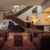 Hotel Hardware Dayton lobby with leather sofas, staircase, and vintage chest