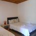 Fire pansiyon in Cirali guest room with two beds and wood-paneled ceiling