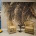 Sovn Experience+Lifestyle Cape Town seating area with palm mural, wicker chairs and tropical decor
