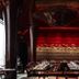 Hotel Les Bains Paris restaurant with red-lit wall, dark columns and set dining tables in Paris