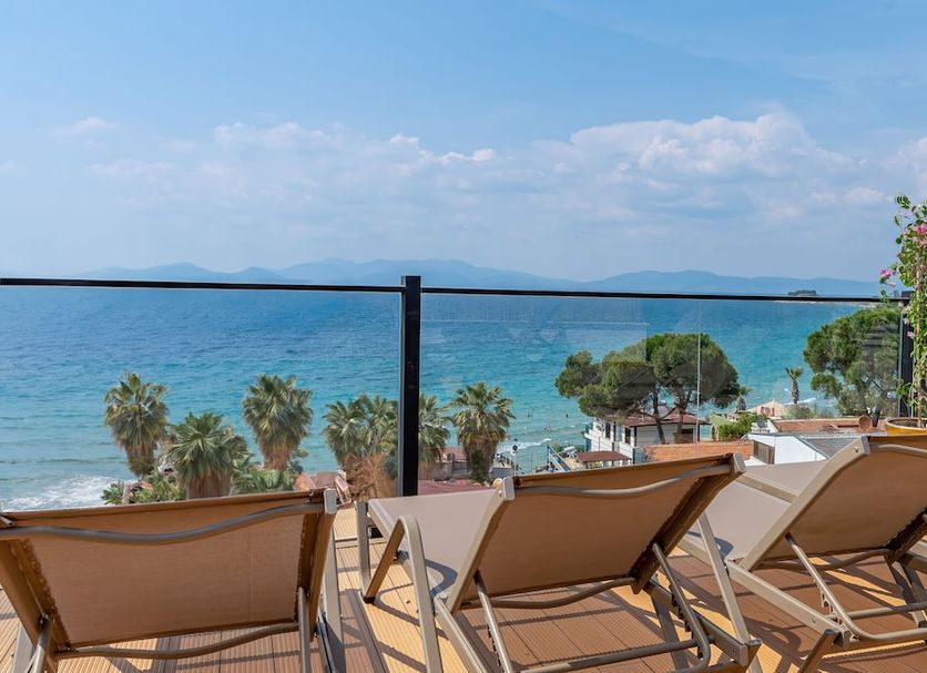 Rosy Suites Hotel in Kusadasi terrace with loungers overlooking the sea and beach