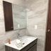 The Beach Guesthouse La Torre bathroom vanity with sink, mirror and towels