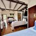 Hotel & Restaurant Fleur De Lis in Concepción de Ataco: rustic guest room with multiple beds and wood-beam ceiling