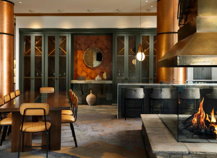 Renaissance Boulder Flatiron Hotel in Broomfield lounge with dining table, fireplace, and bar seating