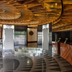 Quentin Boutique Hotel Berlin lobby with curved wooden ceiling, glass display table and front desk