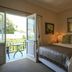 Oude Berg Guesthouse, George: bedroom with open doors to a balcony and garden view