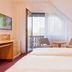 Hotel garni Sonnenhof Moritzburg guest room with balcony door, sitting area and twin beds