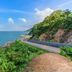 Sri Phairin Resort in Chanthaburi with oceanfront road beside lush green hillside and blue sea