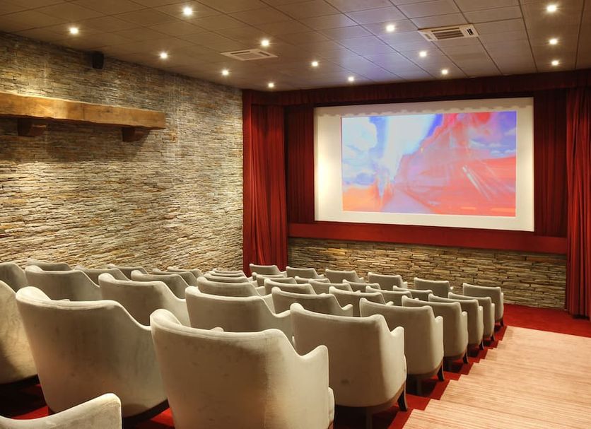Les Manoirs de Tourgéville in Deauville: hotel cinema room with rows of plush seats and a large screen