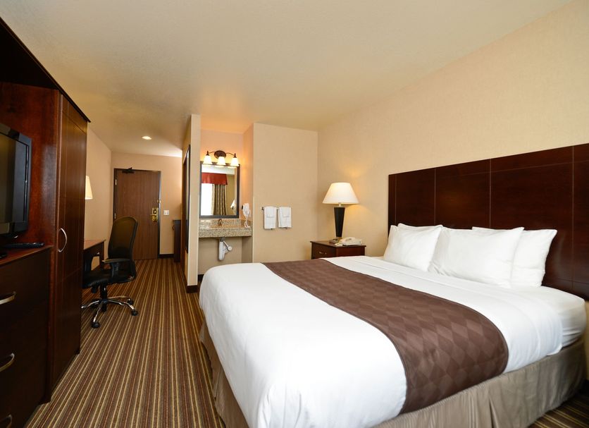 Yellowstone West Gate Hotel room in West Yellowstone with king bed, desk and TV