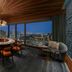 Hilton Saigon in Ho Chi Minh City lounge with round table and city skyline views at dusk