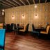 OYO The Leven, Felixstowe: cozy dining area with patterned wallpaper and upholstered chairs