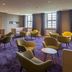 Kardinal Schulte Haus in Bergisch Gladbach lounge with purple carpet, seating area and large windows