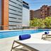 Sercotel Madrid Aeropuerto rooftop pool with loungers and city views in Madrid