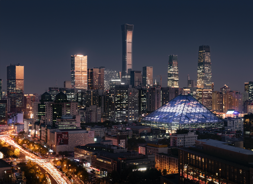 Hotel Eclat Beijing, an SLH Hotel skyline view of Beijing at night with a lit glass pyramid building