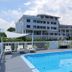 Emerson Inn By The Sea in Rockport with outdoor pool, lounge chairs, and waterfront hotel view