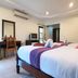 Lanta White Rock in Ko Lanta: twin beds in a simple guest room with desk, TV, and air conditioning.