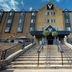 Village Hotel Newcastle in Newcastle upon Tyne, front entrance with wide stone steps and blue awning