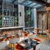 Le Cinq Codet, Paris: modern restaurant interior with glass ceiling, tables, chairs and wine wall