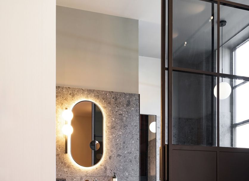 Van der Valk TheaterHotel De Oranjerie Roermond bathroom with lit oval mirror and vanity
