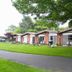 Nader's Motel & Suites in Ludington, with single-story suites, lawn, trees, and patio seating
