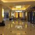 Shell House Hotel in Baoding lobby with polished floors, columns, and warm ceiling lights