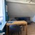 Haus Hohensee in Clausthal-Zellerfeld: cozy room with table, chairs, sofa and wooden cabinet