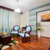 Çetinel Otel in Adana guest room with sitting area, blue chairs, hardwood floor and large curtains