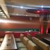 Hotel The Taksonz, Ludhiāna: restaurant with long tables, booths and red-lit central pillar