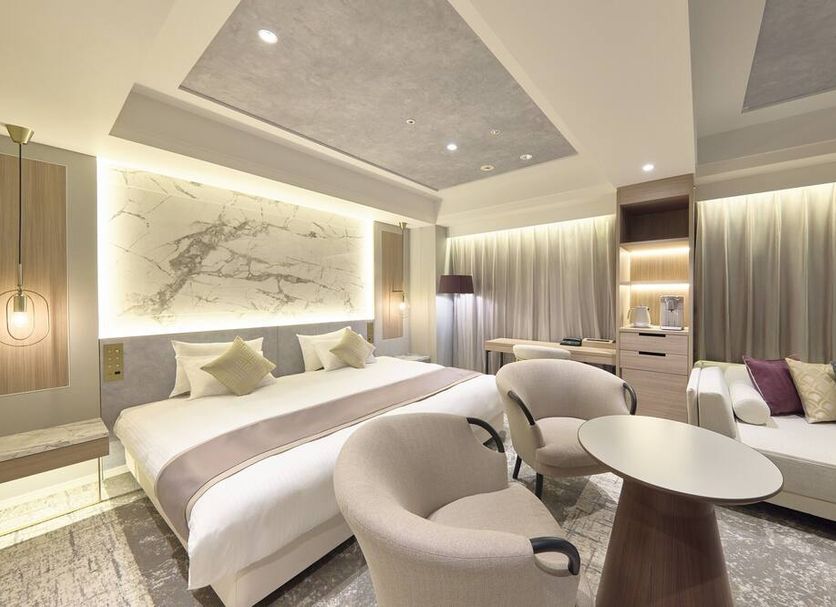 Villa Fontaine Grand Tokyo Roppongi guest room with king bed, sofa, and marble table in Tokyo