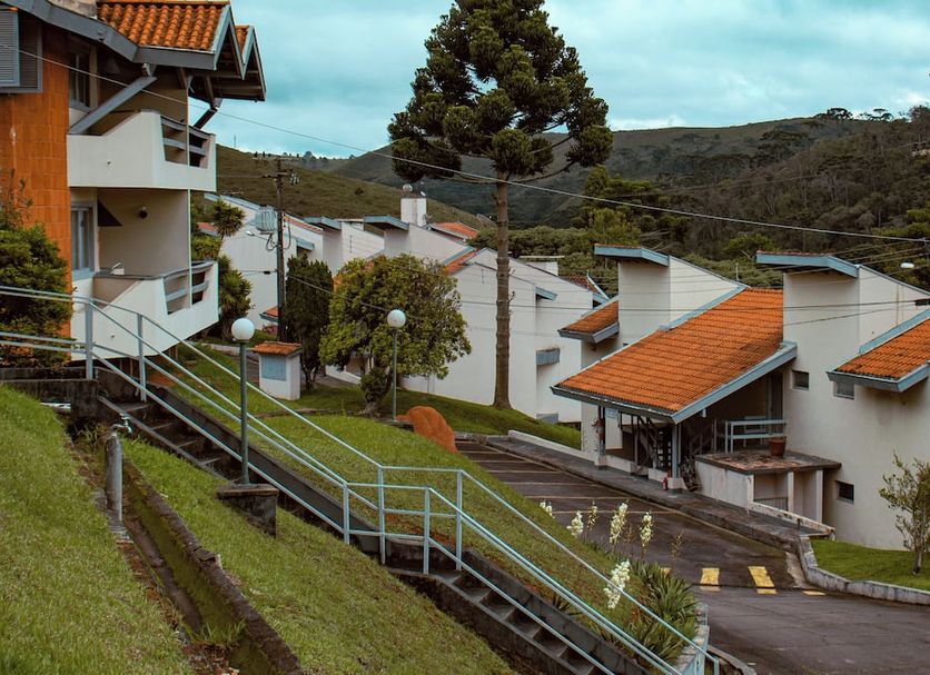 Plaza Inn Week Inn in Campos do Jordão with hillside chalets, orange roofs, and mountain views
