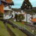 Plaza Inn Week Inn in Campos do Jordão with hillside chalets, orange roofs, and mountain views