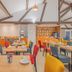 Sure Hotel by Best Western Mougins Belvedere breakfast room with tables, orange accents, and exposed beams